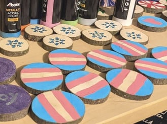 rustic wood ornaments painted with transgender pride flag