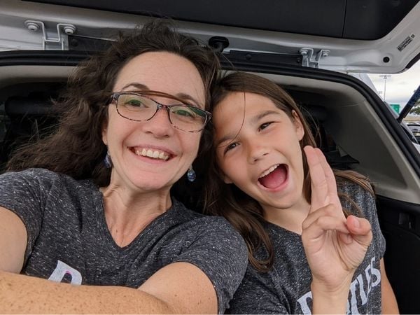 mother and daughter wearing matching shirts smiling ecstatically